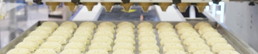 Large machinery demonstrating cupcakes being packaged