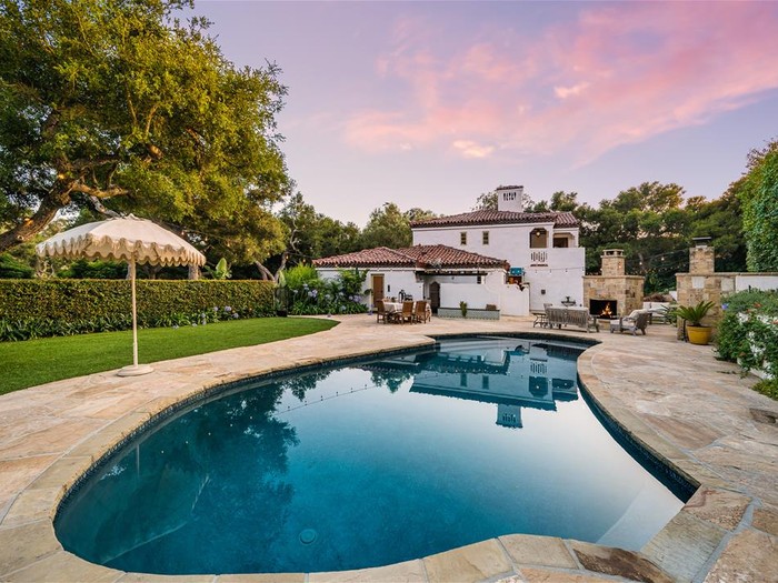 a-large-home-with-a-large-swimming-pool-in-front-o-2025-02-11-19-46-10-utc